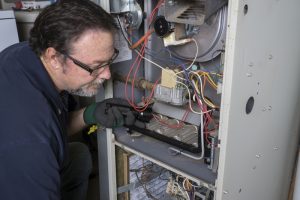 technician-looking-over-heater