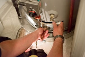 Technician repairing a water heater.