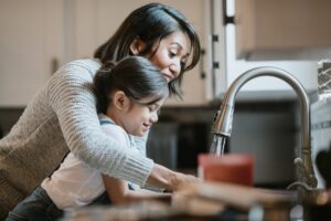 woman-and-child-using-kitchen-sink