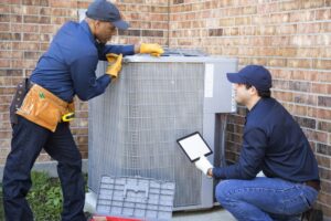 technicians-work-on-air-conditioner-cabinet